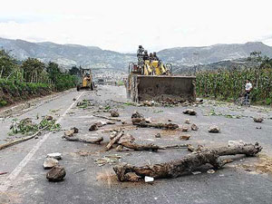 Los ind�genas de Peguche colocaron varios troncos de �rboles en la v�a y un tractor los retir� (foto: El Comercio)